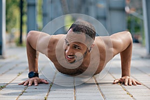 Strong muscular handsome man doing push ups