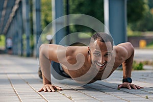 Strong muscular handsome man doing push ups