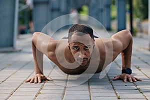 Strong muscular handsome man doing push ups
