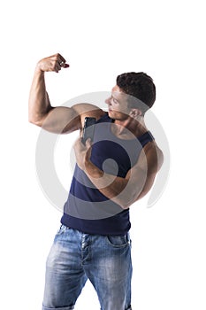 Strong muscular man flexing his arm muscles