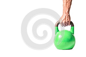 Strong muscular man hand with muscles holding green heavy kettlebell partially isolated on white background