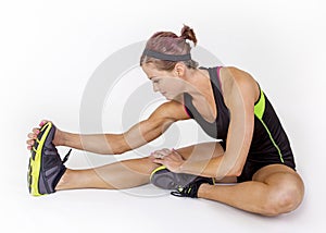 Strong muscular woman stretching before workout on white background