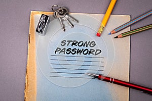 STRONG PASSWORD. Privacy, data protection and security concept. Notebook and office supplies on a gray background
