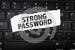 Strong Password. Torn paper on a black computer keyboard