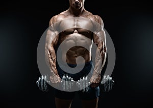 Strong and power bodybuilder doing exercises with dumbbell