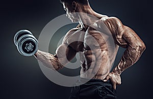 Strong and power bodybuilder doing exercises with dumbbell