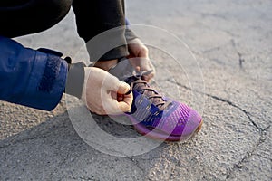 strong runner tie shoelaces before run on the asphalt b