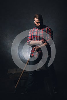 Strong rural worker on dark background