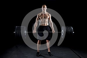 Strong man deadlifts a lot of weight photo