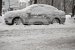 After a strong snow storm car covered in snow