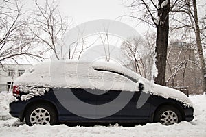 After a strong snow storm car covered in snow