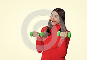 Strong sport girl lifting a barbell with determination. teen sport girl pushing limits with a barbell workout. Motivated