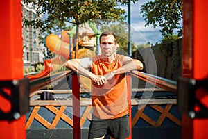 Strong Sport Man Is Training Outdoor City. Young man doing push-ups during outdoor