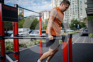Strong Sport Man Is Training Outdoor City. Young man doing push-ups during outdoor