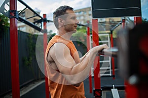 Strong Sport Man Is Training Outdoor City. Young man doing push-ups during outdoor