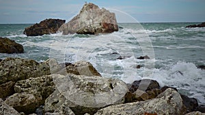 Strong storm near a rocky coast, white waves with foam in the sea, Black Sea, Bulgaria