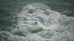 Strong storm near a rocky coast, white waves with foam in the sea, Black Sea, Bulgaria