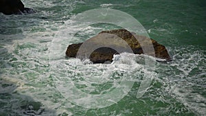 Strong storm near a rocky coast, white waves with foam in the sea, Black Sea, Bulgaria