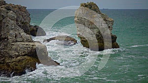 Strong storm near a rocky coast, white waves with foam in the sea, Black Sea, Bulgaria