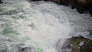 Strong storm near a rocky coast, white waves with foam in the sea, Black Sea, Bulgaria