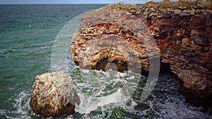 Strong storm near a rocky coast, white waves with foam in the sea, Black Sea, Bulgaria