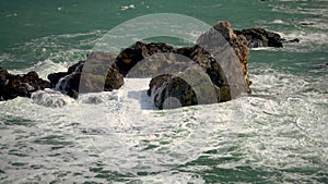 Strong storm near a rocky coast, white waves with foam in the sea, Black Sea, Bulgaria