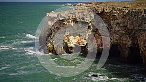 Strong storm near a rocky coast, white waves with foam in the sea, Black Sea, Bulgaria