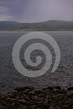 Strong summer storm. Water bubbles formed on the surface of the lake due to heavy rain