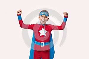 Strong superhero celebrating victory in studio
