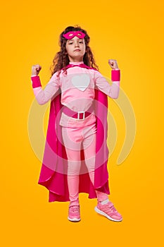 Strong superhero kid in pink outfit