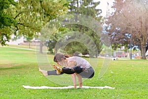 Strong supple woman working out in a park