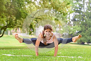 Strong supple woman working out in a park