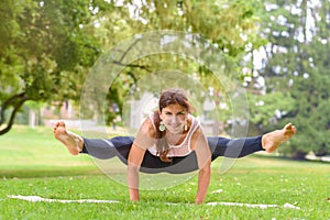 Strong supple woman working out in a park photo