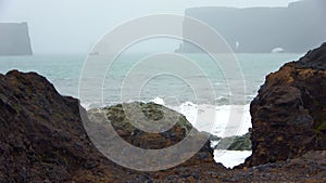 Strong surf at the basalt rocks of dyrholaey on Iceland