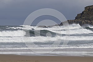 Strong swell with white foam at la Zurriola beach San Sebastian, Spain.