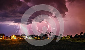 Strong Thunder hitting house with rain over the village street photo