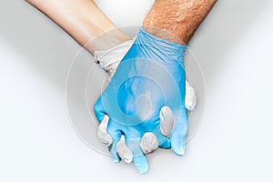 Strong together, couple holding hands with latex gloves