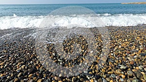 strong wave covers the small pebbles. beautiful sea waves  pebble beach. recreation by the water