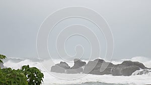 Strong waves crashing against rocks during storm