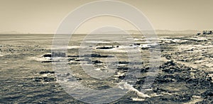 Strong waves, stones and sea cliffs, Sea Point promenade in Cape Town, South Africa