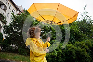 Strong wind has wrest an umbrella in boy's hands.