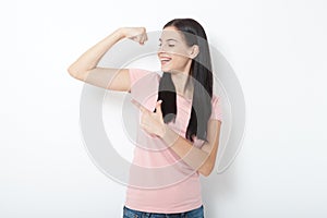 Strong woman. Beautiful girl showing her muscularity, looking at camera