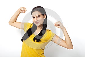 Strong woman. Beautiful girl showing her muscularity, looking at camera