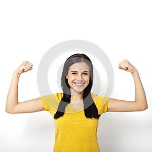 Strong woman. Beautiful girl showing her muscularity, looking at camera