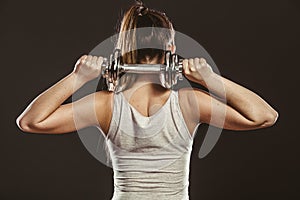 Strong woman lifting dumbbells weights. Fitness.