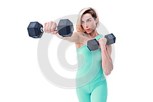 Strong woman punching with barbells in hands during boxing class on white background. One girl working out in studio