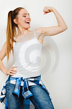 Strong woman showing off muscles. Strength.