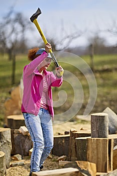 Strong woman  splitting beech logs