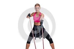 Strong woman using a resistance band in her exercise routine. Young woman performs fitness exercises on white background