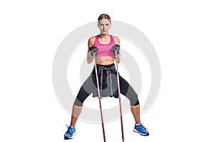 Strong woman using a resistance band in her exercise routine. Young woman performs fitness exercises on white background